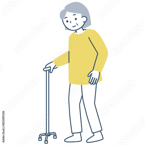 四点杖を使って歩くシニア女性