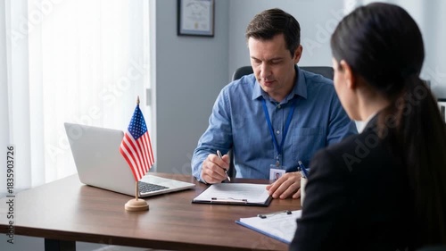 Immigration officer reviewing visa application documents with client at desk, concept of US citizenship interview and legal consultation