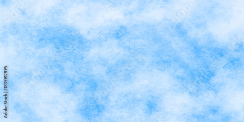 Fluffy white clouds drift across a bright blue summer sky