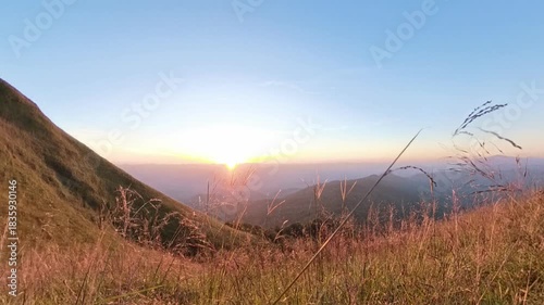
Zoom out effect of 4k sunset blue sky scene on the top of mountain with grass foreground 