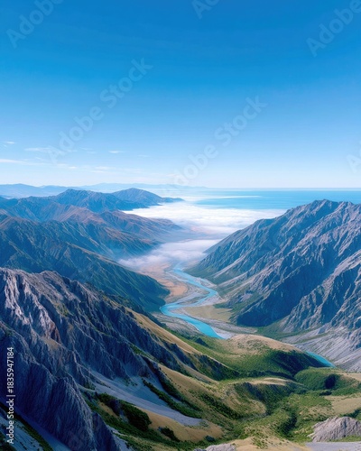 Mountain Valley with River and Clouds Under Blue Sky