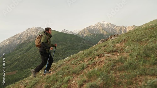 Traveler hiking uphill in mountains with backpack concept of inner strength balance freedom mindfulness exploration self discovery motivation nature connection and peaceful journey