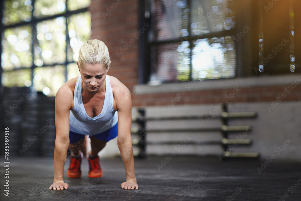 Fototapeta premium Gym, workout and woman with balance, push ups or fitness for body strength with endurance and health. Training, bodybuilder and person on floor with challenge, active and exercise for muscle gain