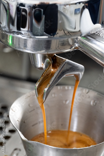 Close-up shot of dual Spout Espresso Pour into Stainless Cup