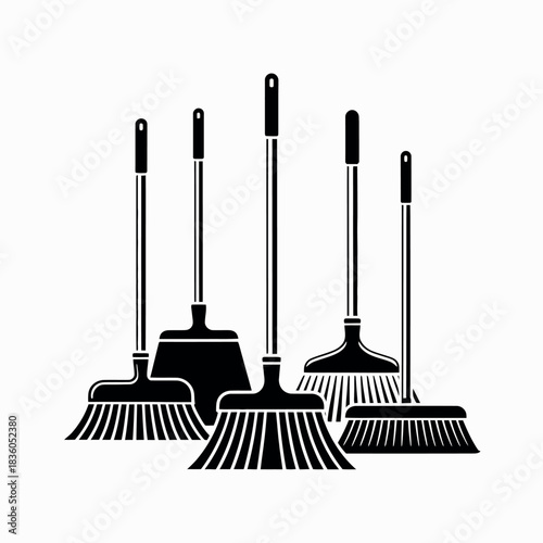 Collection of various brooms and dustpans for cleaning and tidying