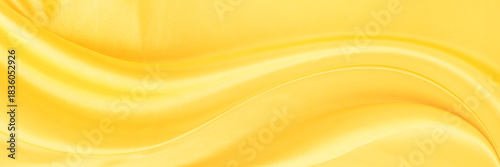 yellow gold satin texture that is white silver fabric luxurious shiny that is abstract silk cloth background with patterns soft waves blur beautiful.