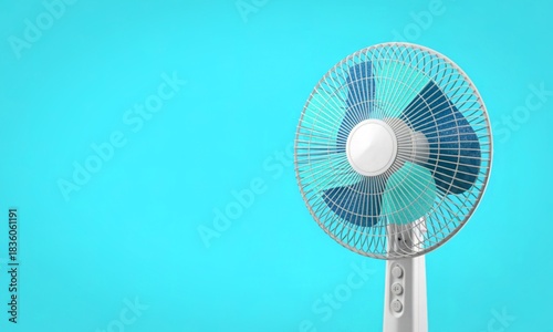 Close up of a modern electric fan against a bright blue background