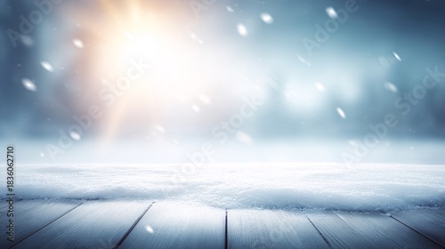 Winter scene with wooden surface snow falling and blurred trees background.