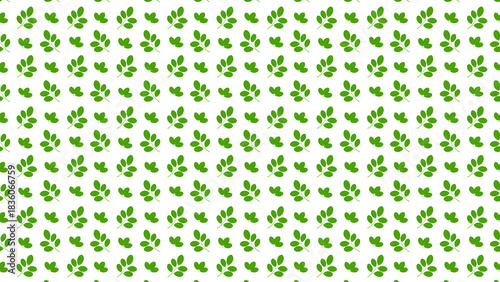 Repeating pattern of green leaves scattered on a white background creating a botanical design effect