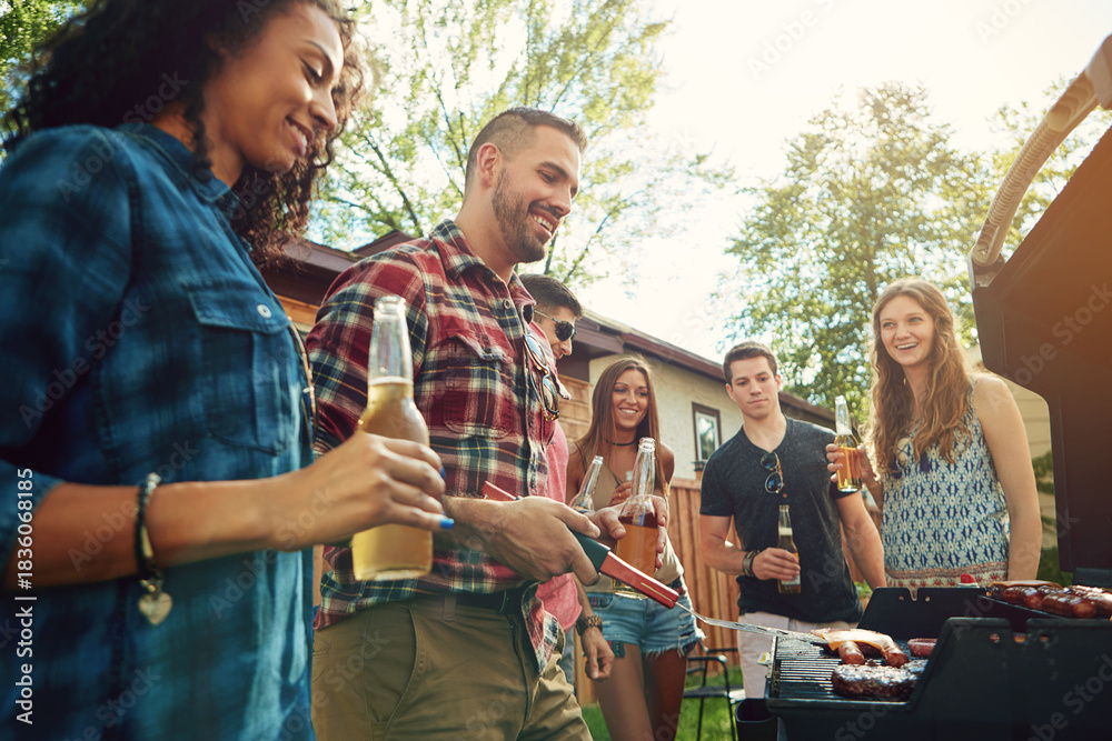 Fototapeta premium Friends, barbecue and people with meat, backyard and meal prep for party, happy and social gathering. Outdoor, cooking and group with alcohol for reunion, smile and together for bbq, event or house