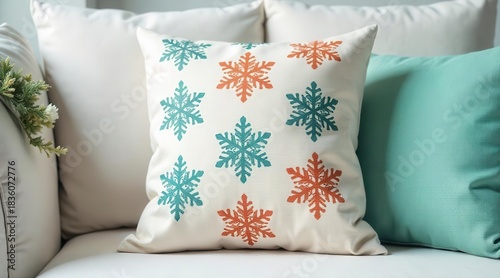 Cozy decorative accent throw pillow featuring a repeating pattern of teal and burnt orange winter snowflake motifs displayed on a soft neutral surface