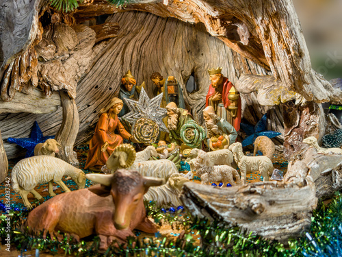Εκτύπωση καμβά Close-up of an elaborate nativity in a large wooden stall: Mary, Joseph, the baby Jesus, kings, shepherds and sheep, ox and donkey in decorative setting