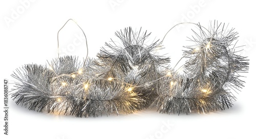 Silver tinsel garland with warm white fairy lights, isolated on a white backdrop