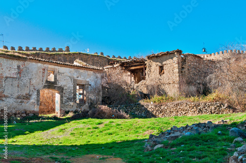 Old abandoned buildings with castle wall in Buitrago de Lozoya