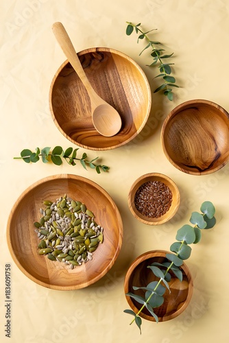 Wallpaper Mural Wooden bowls with seeds and eucalyptus branches on a light yellow background Torontodigital.ca