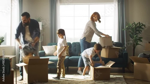 Family moving into new home unpacking cardboard boxes and furniture