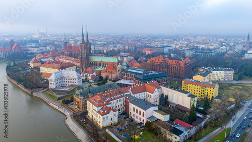 Wallpaper Mural Aerial view of Wrocław’s Ostrów Tumski with the Oder, cathedral, historic buildings, red rooftops and the city skyline in light fog Torontodigital.ca