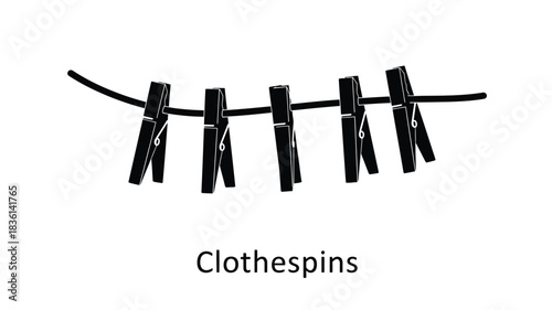 A simple line of black wooden clothespins hanging from a dark cord