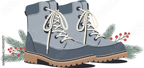 Pair of blue and grey winter boots with light brown soles and white laces, adorned with festive pine branches and red berries.