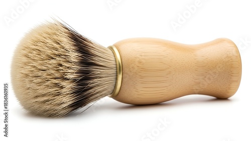 Close-up of a shaving brush with a light wood handle and a dense, two-toned bristle head