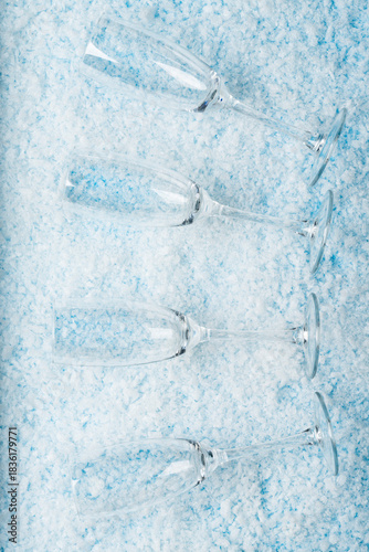 Champagne Glasses on Snowy. New Year celebrations, festive toasts, winter holiday designs, party invitations,