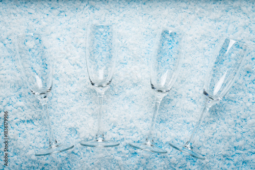 Champagne Glasses on Snowy. New Year celebrations, festive toasts, winter holiday designs, party invitations,