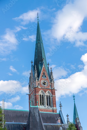 A tower of Majestic church Herz Jesu Kirche against blue sky in Graz, Styria, Austria.