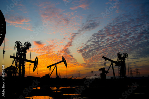 The oil pump, industrial equipment. Oil field site, oil pumps are running.