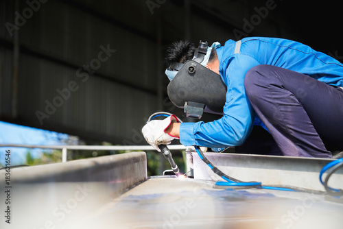Industrial welder welding fabricated stainless construction work in factory, Welding process by Gas Tungsten Arc Welding - GTAW.