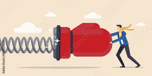 Businessman pushing a giant boxing glove attached to a spring overcoming challenges
