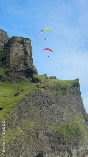 Paragliders Flying Above Green Cliff Scenic Landscape Background