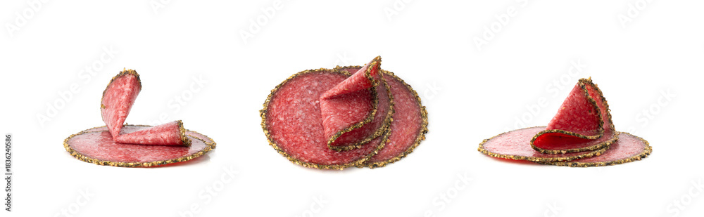 Naklejka premium Pepper salami cuts isolated, thin sausage slices. Sliced dry chorizo, sausages round pieces