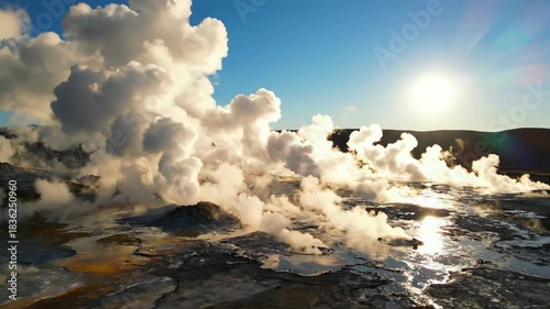 Sweeping aerial view over a vast geothermal steam field with thick atmospheric white vapor rising dramatically into the clear morning light view, energy, heavenly