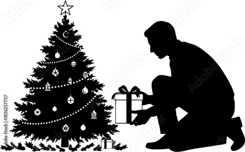 Silhouette of a man carefully placing a present under the Christmas tree.
