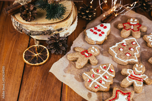 Christmas new year background, traditional festive gingerbread and tangerines with fir branches, cones and decorations, dish design idea, bakery concept,