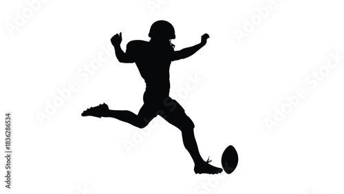 American football player kicking ball