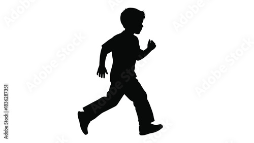Young boy running freely in silhouette