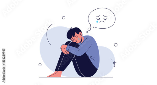 Illustration of a depressed and sad young man sitting huddled on the floor crying, with his sorrow reflected in a thought bubble.