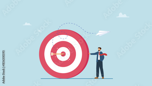 Confident businessman stand with arrow hit bullseye on archery target. Business objective, purpose or target, goal and resolution to aim for success, aspiration and motivation to achieve goal.