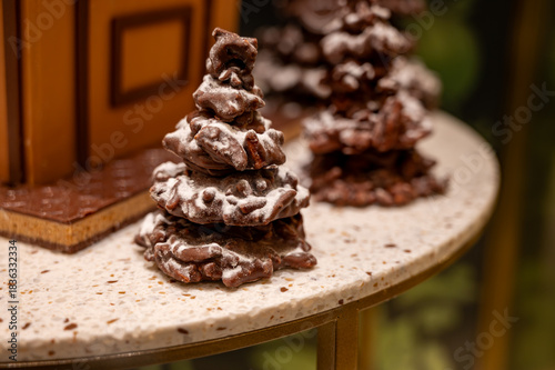 Christmas cookies, decorated with icing and chocolate gingerbread Christmas tree on display in confectionery shop in London, UK