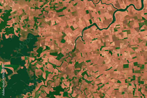 Aerial view of a winding river cutting through varied terrain and vegetation