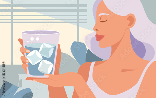 A young woman enjoys a refreshing drink with ice cubes, experiencing a moment of cool tranquility and hydration