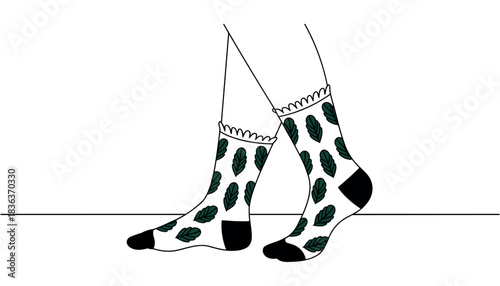 Two feet wearing white socks with dark green leaf pattern and black toe and heel accents legs