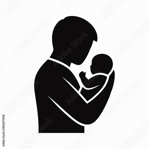 Silhouette of a father holding his newborn baby