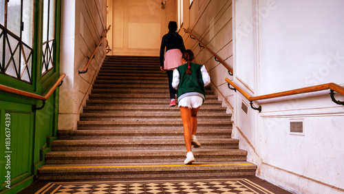 Family tourism. A woman with her daugher entering the museum