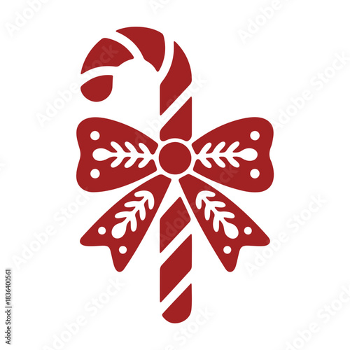 A festive red candy cane with white stripes and a decorative bow for christmas holiday season treat