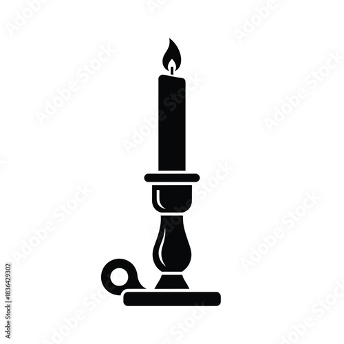 Black silhouette of a lit candle in a candlestick flame