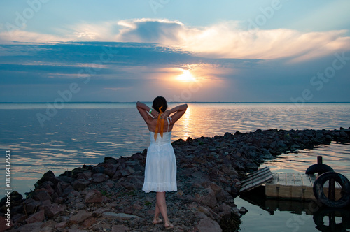 Sunset beach and sky with seascape. Summer sea beach sunrise. Girl at romantic sunset horizon. Silhouette girl sunrise. Romantic woman at sunset sea beach in summer. Woman at sea sunrise. Crimson sky