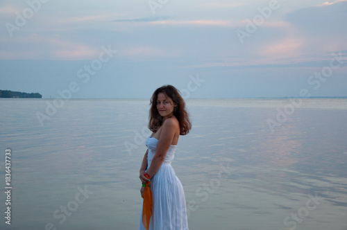 Sunset beach and sky with seascape. Summer sea beach sunrise. Girl at romantic sunset horizon. Silhouette girl sunrise. Romantic woman at sunset sea beach in summer. Woman at sea sunrise. Pastel dusk