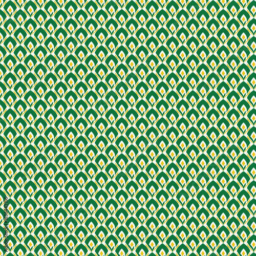 Intricate emerald green and golden yellow geometric pattern with repeating scaled motifs creating a textured visual effect